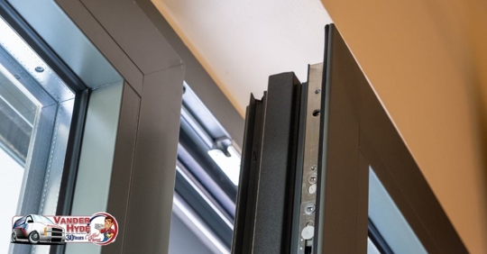 A black metal door slightly ajar from frame